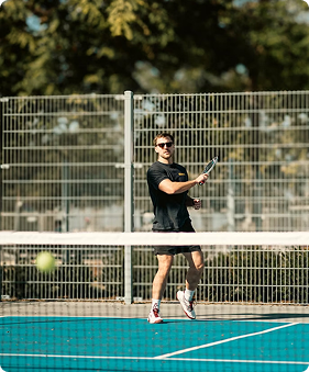 Player in action on blue padel court